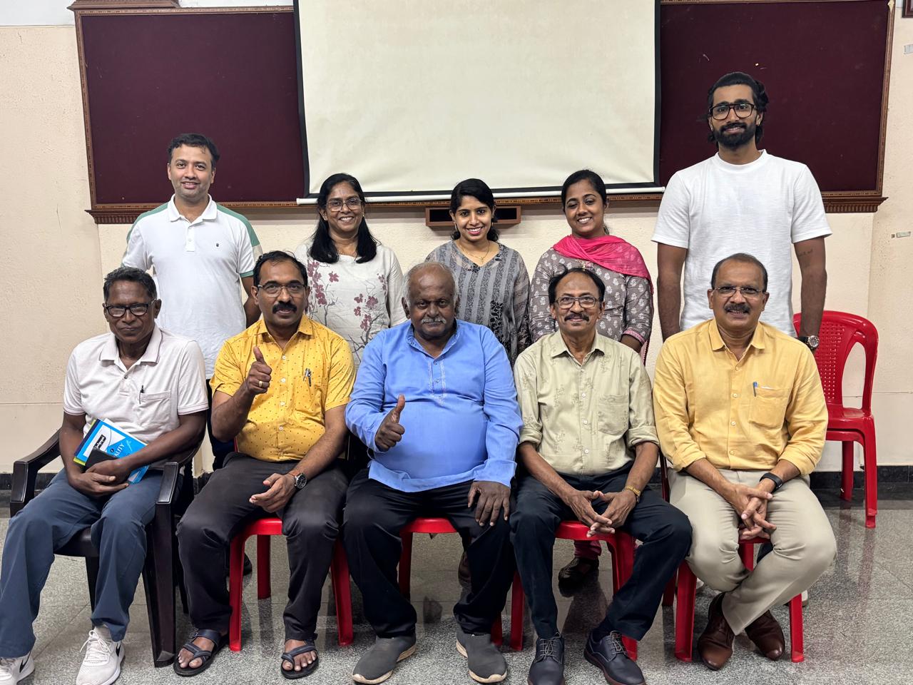 Power of determination at Meeting 636: ten members of Trivandrum Toastmasters Club in the group photograph, two seated members giving a thumbs-up