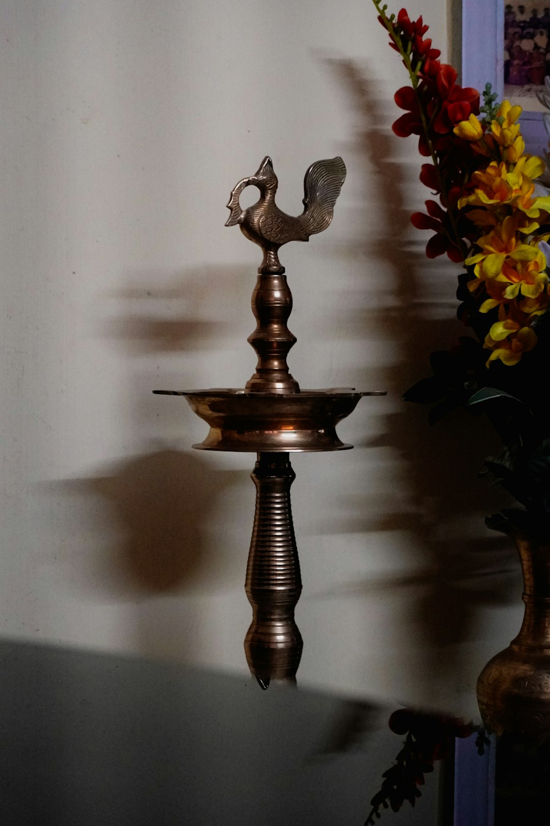 Ornate brass oil lamp lit for Navaratri pooja, a symbol of Navaratri and women's strength and wisdom
