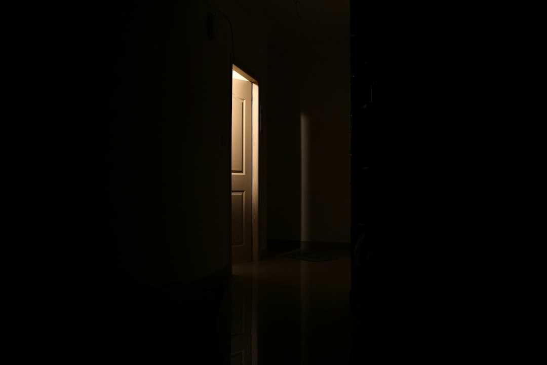 A partially open door letting warm light into a dark room, a symbol of the turning point after my job interview
