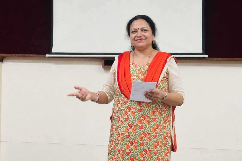Smitha speaking at a Toastmasters meeting, encouraging women to stop postponing what matters to them